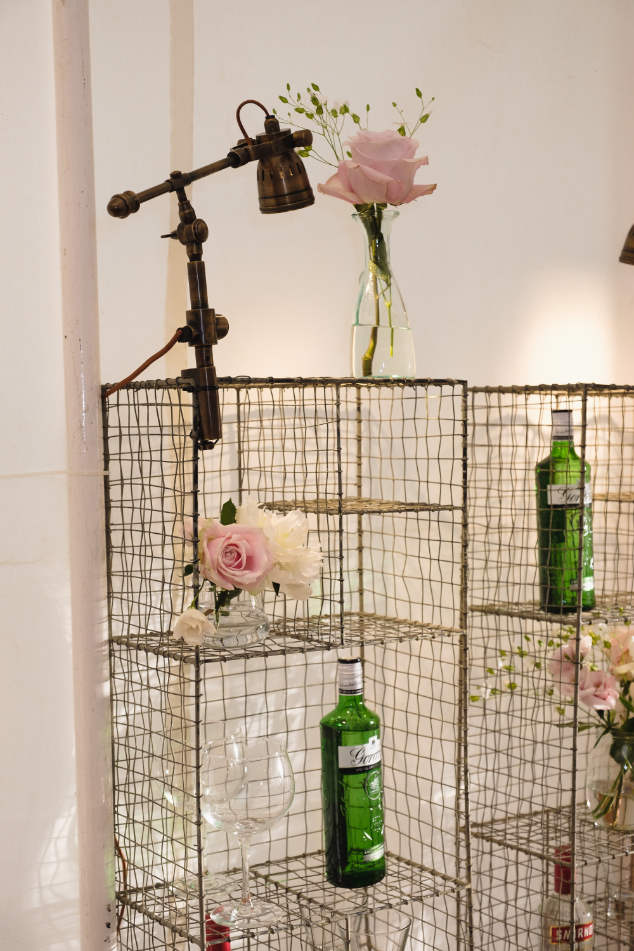 Shelving behind bar with flowers